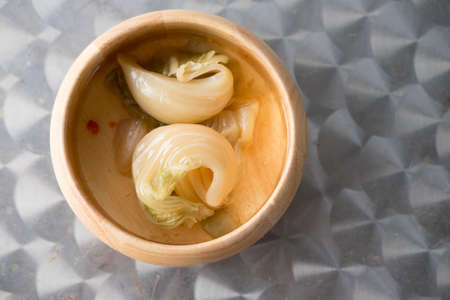 Spicy pickled cabbage salad on wooden bowlの写真素材