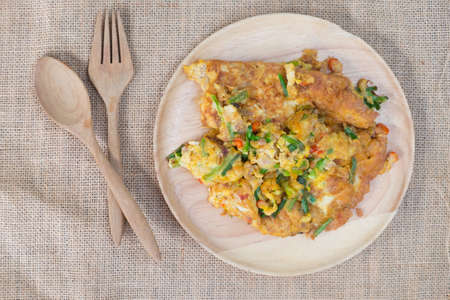 Thai style omelet with vegetable on wooden dishの写真素材