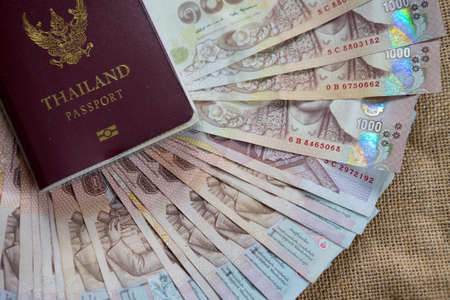 Thai Passport with Thai money banknote, The passport of Thai citizen on Thai banknoteの写真素材