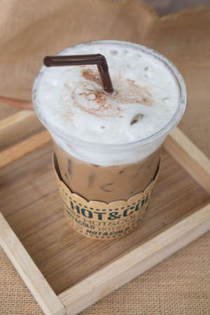 Cold coffee refreshment drink on wood desk in cafe