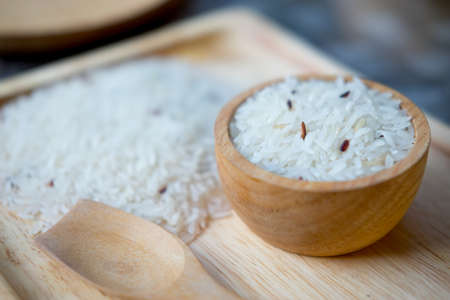 White rice (Thai Jasmine rice) in wooden bowl, selective focusの写真素材