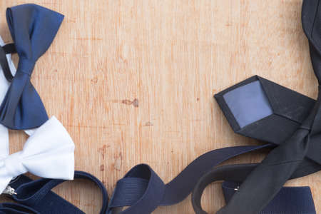 Set of man's accessories (bowtie and necktie) on wood table with copy spaceの写真素材
