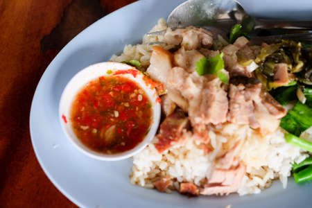 Close up Thai pork leg pot stewed with rice on wooden tableの写真素材