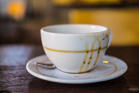 Empty hot coffee cup after drink on wood tableの写真素材