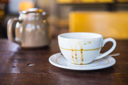 Empty coffee cup after drink on wood table in vintage styleの写真素材