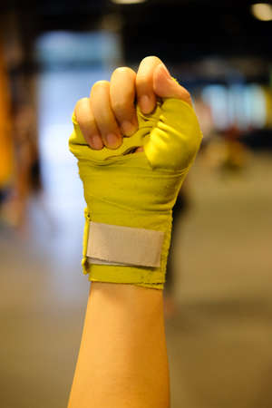Close up female hand of boxer with green boxing bandagesの写真素材