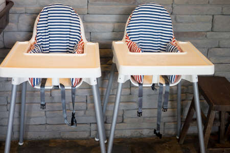 Two empty baby chair at restaurant, cute chairの写真素材