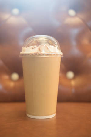 Ice coffee in paper cup with straw in coffee shopの写真素材