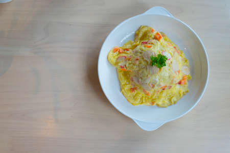 Omelet on Thai Jasmine Rice with carrot and sausage in white dishの写真素材