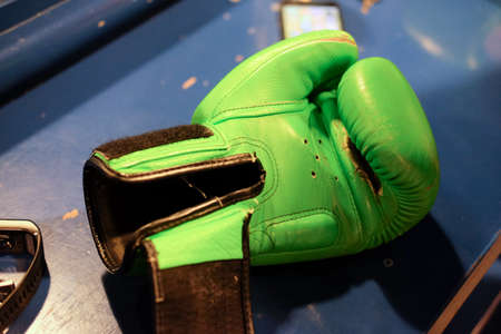 Close up Green boxing gloves on the shelfの写真素材