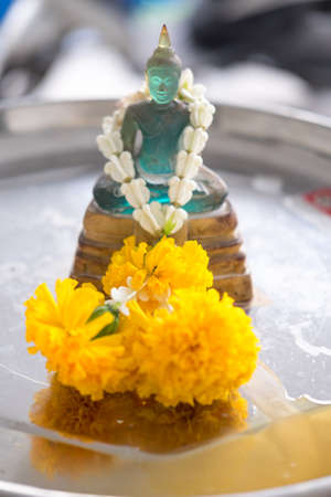 Thai people pouring water (bathing) on Buddha statue in Songkran Festival, Thailandの写真素材