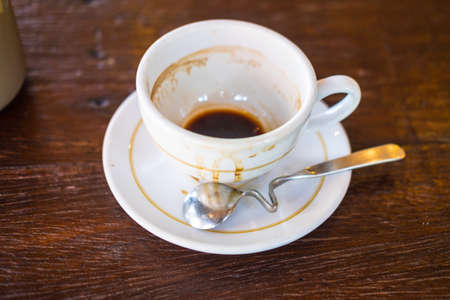 White cup of empty coffee on a wood tableの写真素材