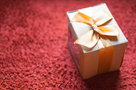 Gift packing process with vintage box and brown paper on red backgroundの写真素材