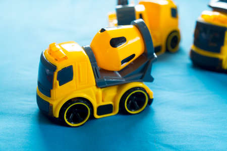 Construction machinery plastic yellow toy on blue bedの写真素材