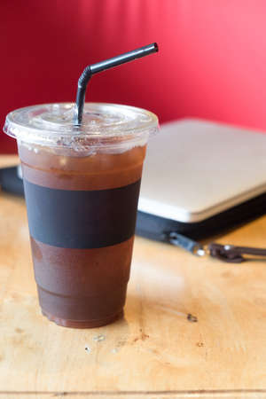 Delicious ice coffee americano on wood table.