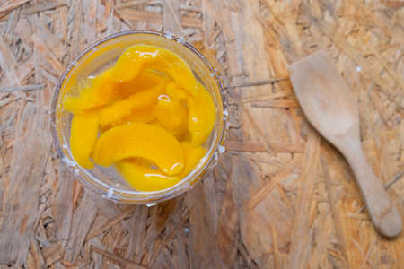 Soda with peach on a wooden table, top viewの写真素材