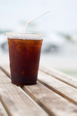 Ice of americano with coffee cafe shop blur backgroundの写真素材
