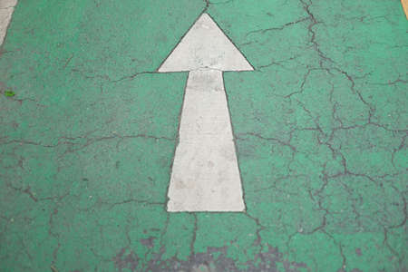 White arrow on old road in the park