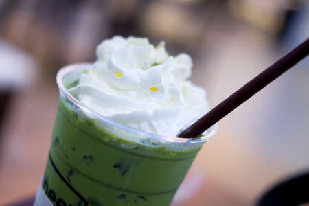 Close up whipped cream on ice green teaの写真素材