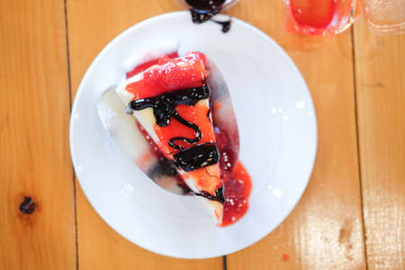 Delicious sweet dessert bakery crepe cake with fresh strawberry and chocolate sauce, selective focusの写真素材