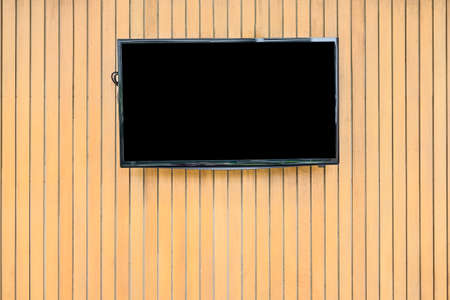 Blank lcd Flat screen television hanging at the planks wooden wallの写真素材