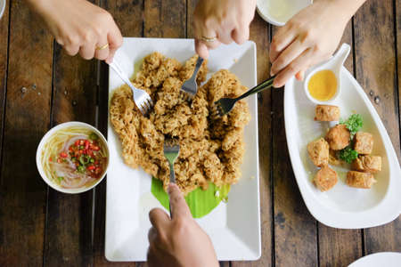 Eating Yam pla duk foo a classic Thai food on wood tablの写真素材