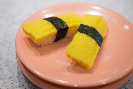 Sweet egg nigiri sushi on pink dish- japanese food styleの写真素材