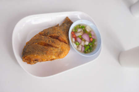 Thai food Deep fried little Tilapia fish call Pla Nil Tod in served with spicy Thai sauceの写真素材