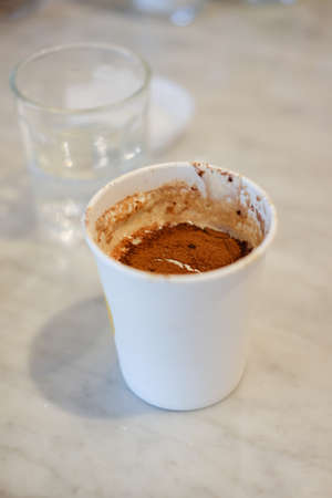 Hot chocolate in paper cup in cafeの写真素材