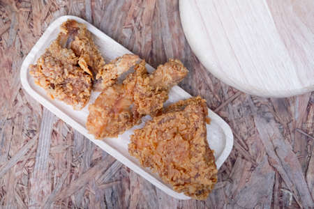Homemade fried chicken meal on wood dish, top viewの写真素材