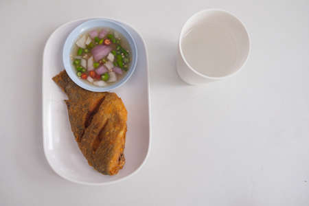 Fried Tilapia fish fried eating with rice on table dinnerの写真素材