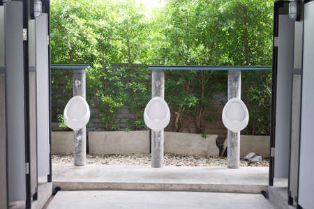 row of outdoor urinal men public toilet white urinals in men bathroomの写真素材