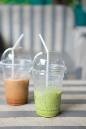 Empty iced milk green tea and iced coffee in coffee shop, after drinkの写真素材