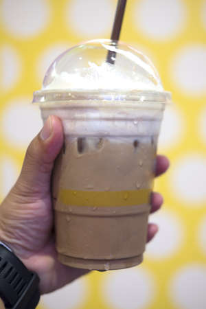 Chocolate frappe with whipped cream in plastic glass
