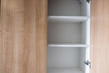Empty open wooden shelf in bright interior decoration in homeの写真素材