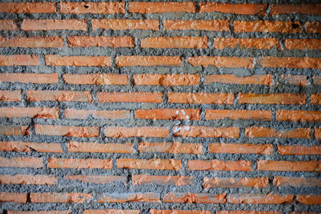 Weathered texture of stained old dark brown and red brick wall background
