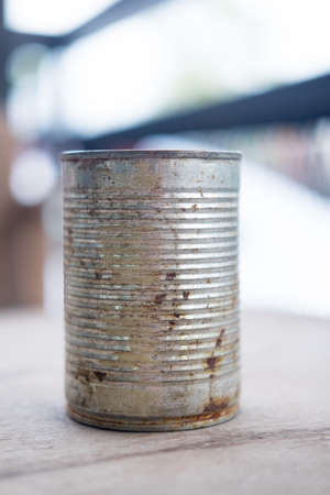 Old empty canned food on wood tableの写真素材