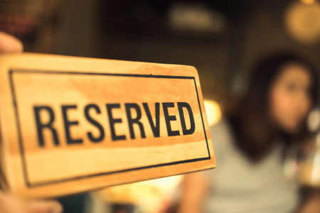 Wood reserved sign with women backgroundの写真素材