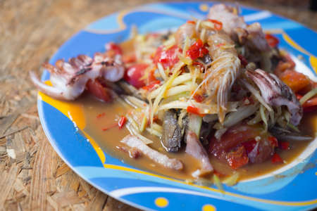 Delicious and spicy seafood papaya salad on dishの写真素材