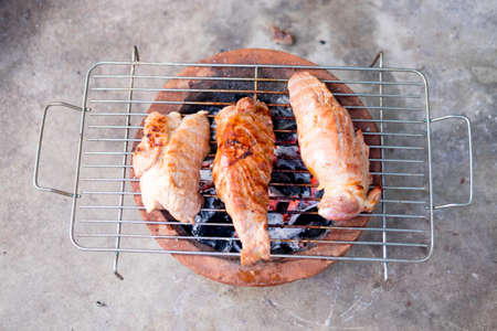 Pork grilling on charcoal stove for picnicの写真素材