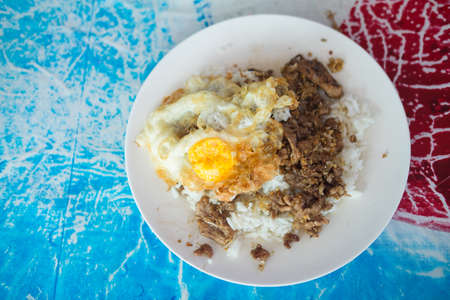 Close up of fried pork with garlic and pepper on rice, Thai food styleの写真素材