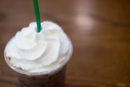 Ice coffee with whipped cream in take a way cupの写真素材