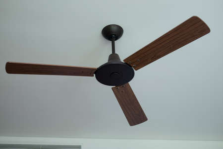 Ceiling fan hanging on the ceiling in living roomの写真素材