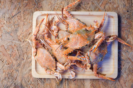 Cooked crab on wooden tray, top viewの写真素材