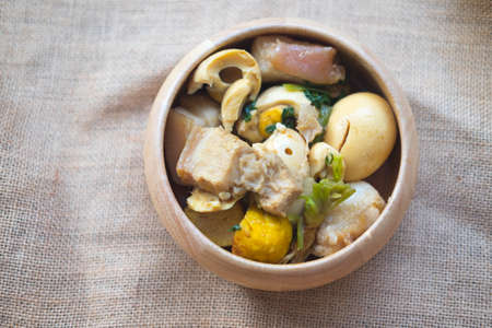 Eggs and chicken in brown sauce chicken stewed in the sweet brown Gravy, Hard boiled egg and stewed chicken in gravy sauce, Thai Cuisine call Kai Pha Loの写真素材