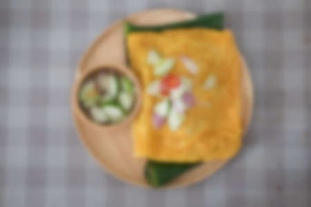 Blur background stuffed crispy egg crepe on wood  dishの写真素材
