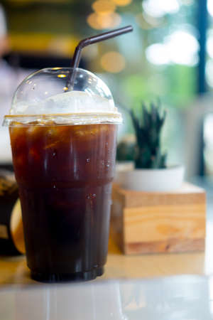 Iced black coffee on wooden table