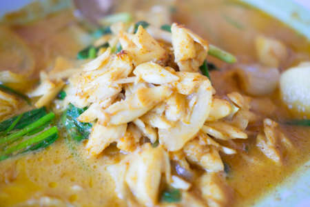Stir fried crab with yellow curry served on the dish