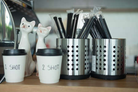 Coffee paper cup and tube in coffee bar at coffee shopの写真素材