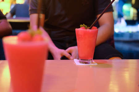Fresh watermelon smoothie frappe in night pub, drink for  lady